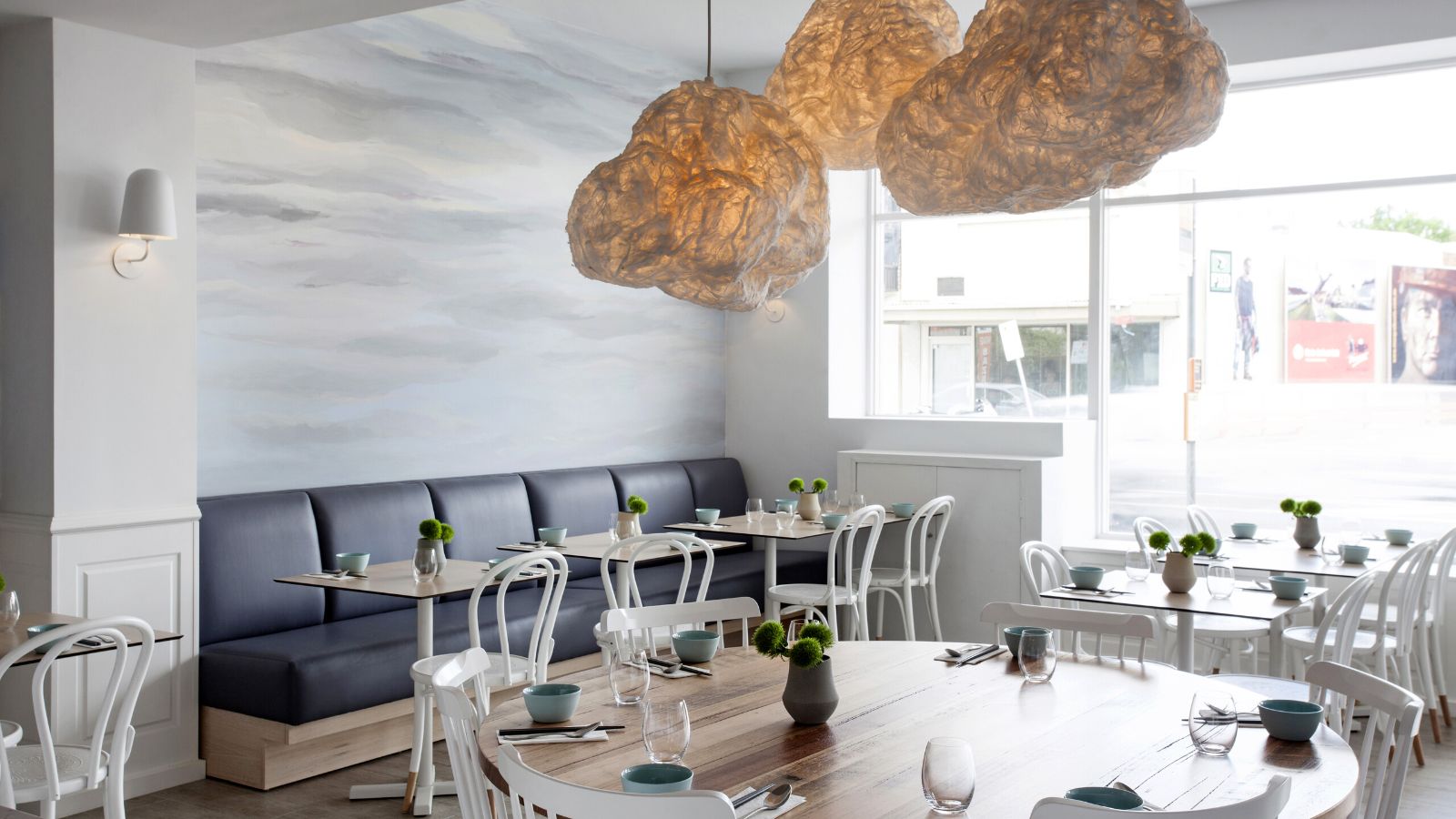 Benjamin’s Kitchen dining room with cloud-shaped pendant lights above the tables