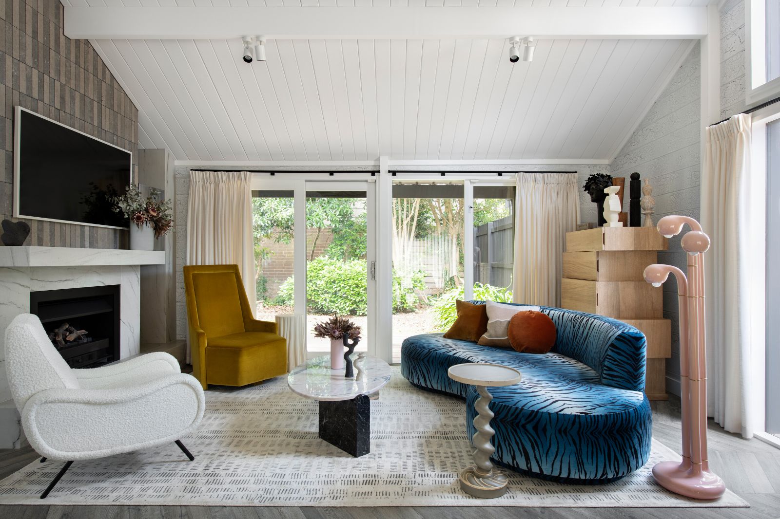Mornington Beach House living room with a curved blue sofa and two armchairs