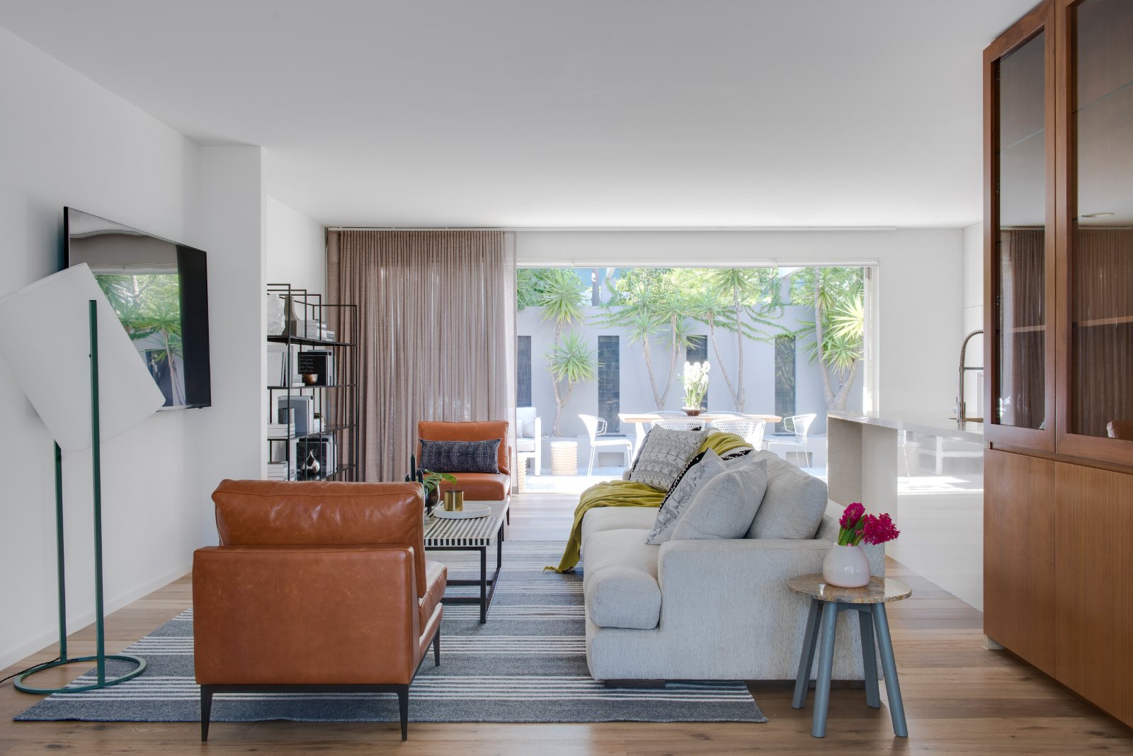 Port Melbourne Beach House living room with sheer curtains drawn to one side of the glass doors