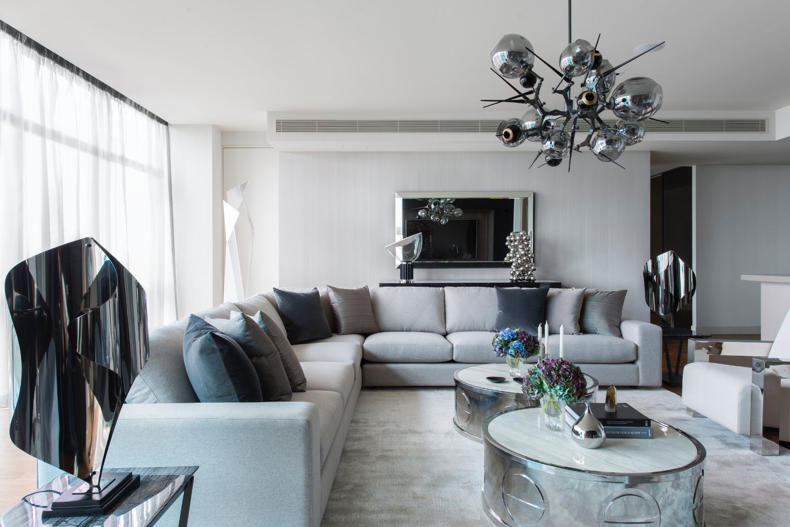 Southbank Pied-à-Terre living room with a smoked glass chandelier above the sofa
