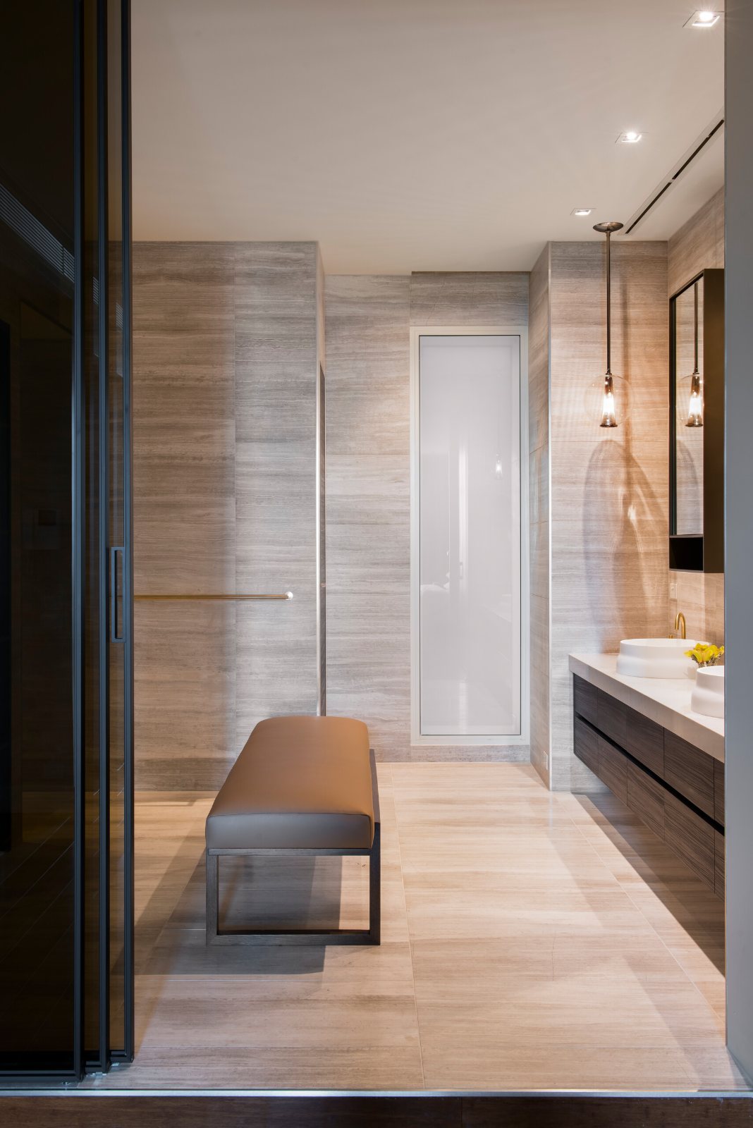 Southbank Pied-à-Terre bathroom lined in stone, with a timber vanity and a bench