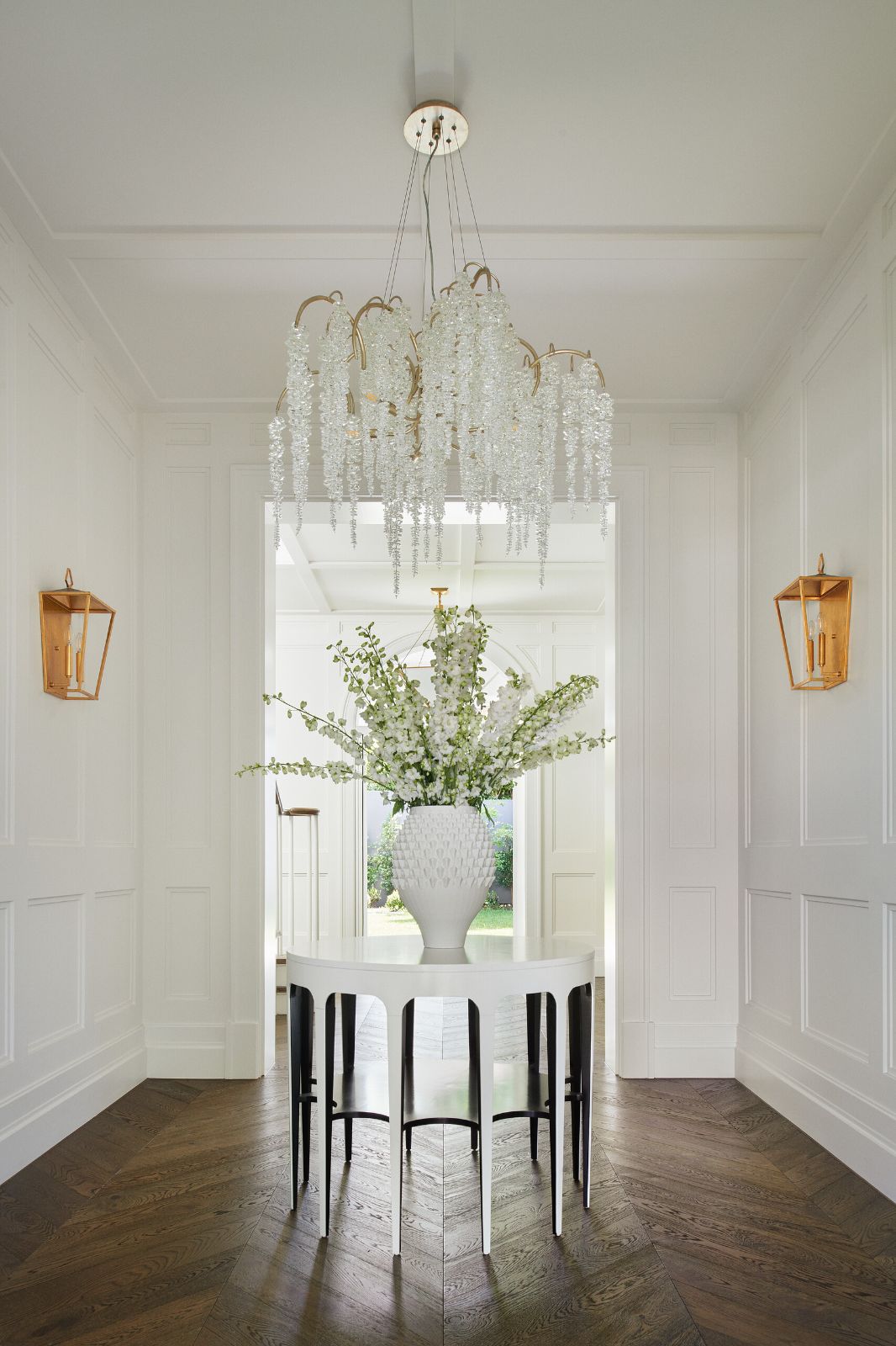 Toorak, Montalto Avenue entrance hall with a crystal chandelier above a round hall table