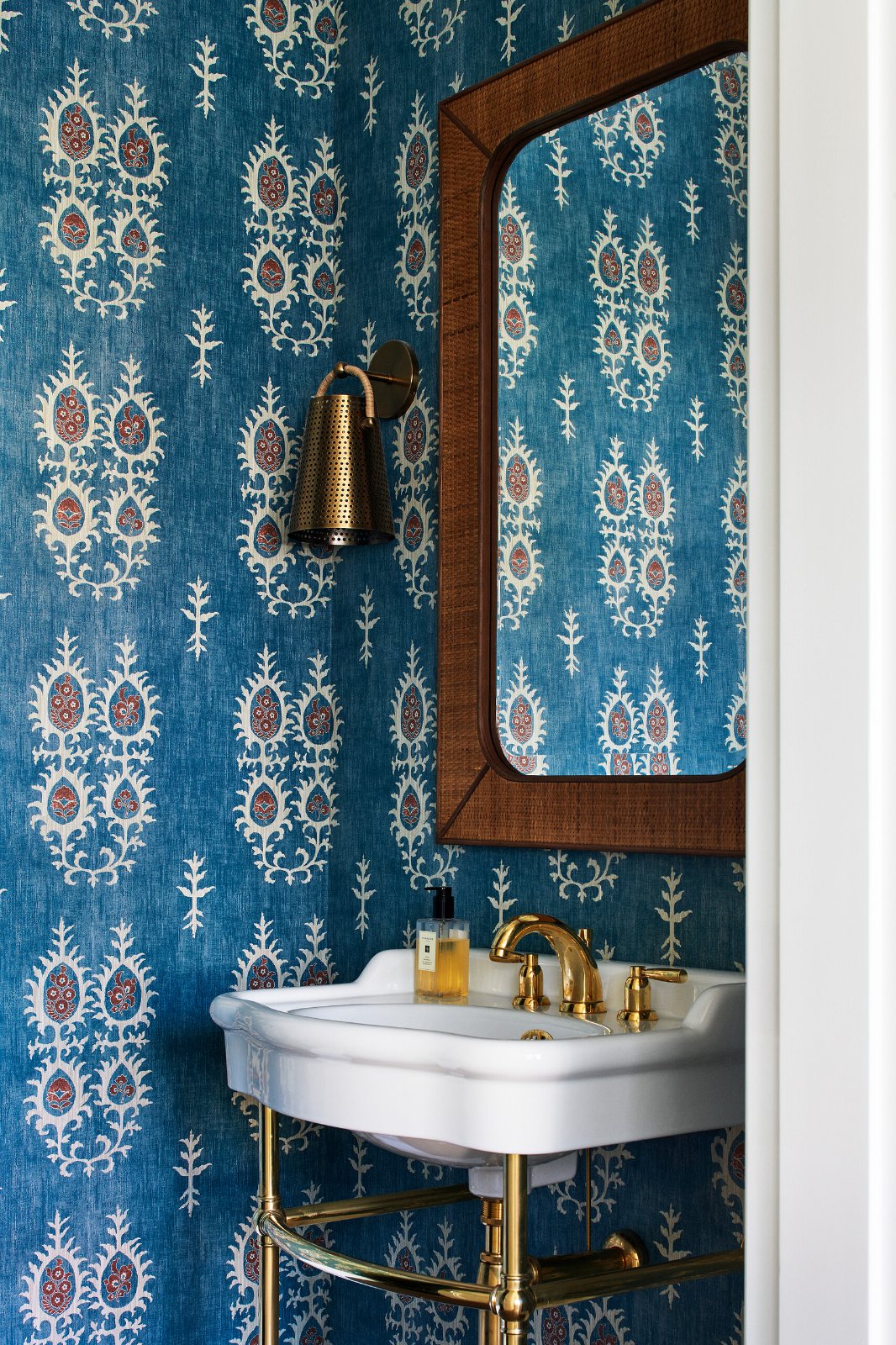 Toorak, Montalto Avenue powder room with a basin on a brass stand against patterned wallpaper